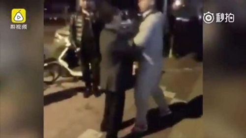 Trung Quốc: Kỳ lạ cảnh 2 người đàn ông đấu nước bọt bên ngoài đồn cảnh sát - Ảnh 1