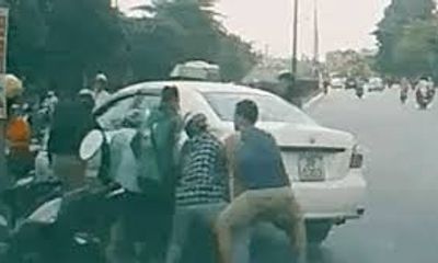 Video: Taxi đè xe máy, cả chục người đi đường lao vào nâng ôtô cứu người