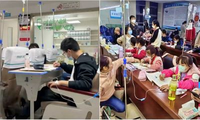 Dịch cúm bùng phát, học sinh Trung Quốc vừa truyền nước vừa làm bài tập về nhà trong bệnh viện